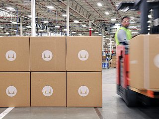 Photo of Herman Miller boxes in a warehouse.